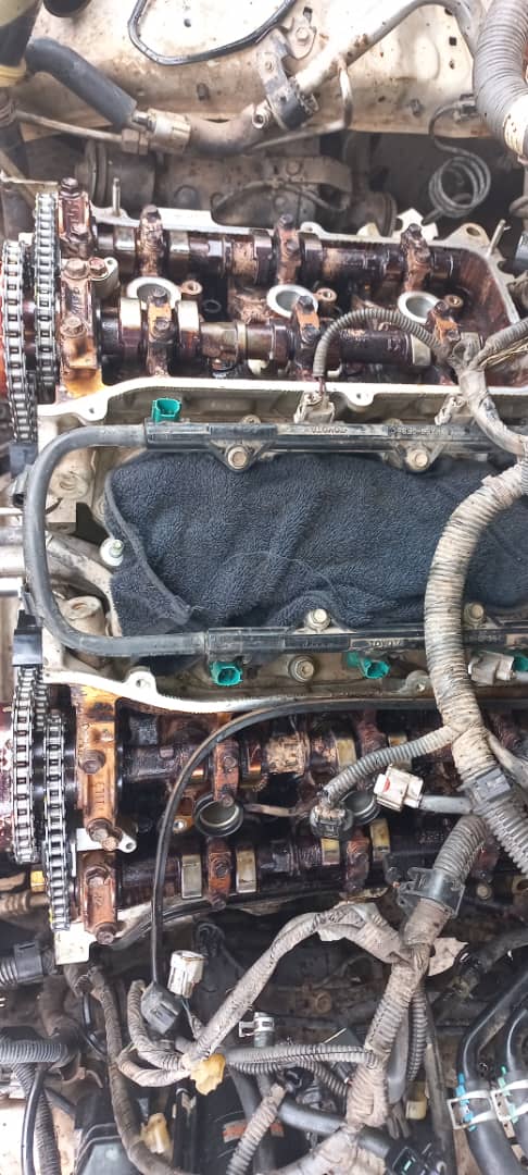 Open engine bay showing camshafts and valve train during overhaul
