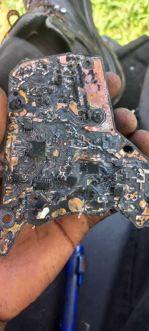 Severely burnt vehicle circuit board held by GTGAS technician