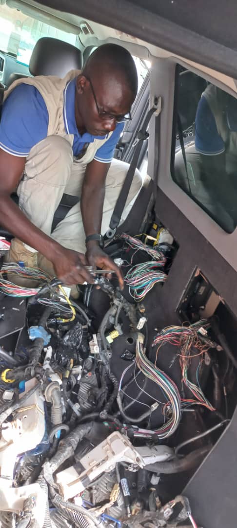 GTGAS technician rebuilding cabin wiring harness inside a vehicle