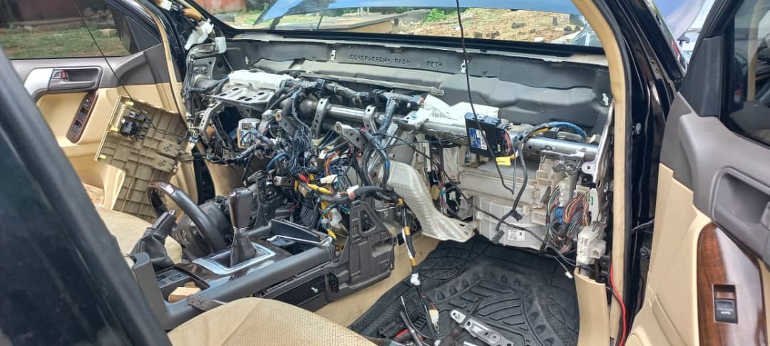 Vehicle interior with dashboard fully removed exposing wiring and HVAC